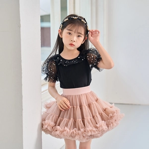 Detail of multi-layered pink mesh tutu skirt with ruffled texture for young girls
