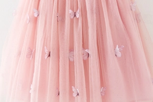 Detail of pink tutu skirt with 3D butterfly appliques and sparkling sequin mesh fabric