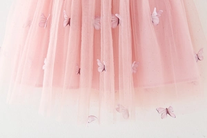 Detailed view of pink mesh tulle skirt featuring 3D embroidered lavender butterflies