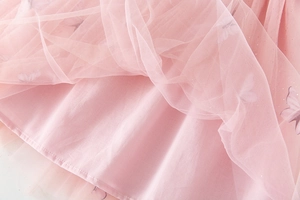 Detail of pink tulle layers with embroidered purple butterflies and silver glitter accents