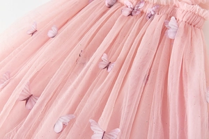 Detail of pink tutu dress with 3D butterfly appliques and sparkling sequin mesh