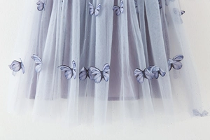 Detail of tulle skirt featuring 3D butterfly appliques and colorful sparkling sequins