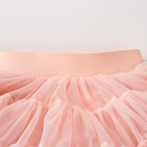 Detailed close-up of pink tutu skirt with elastic waistband and multi-layered soft mesh fabric