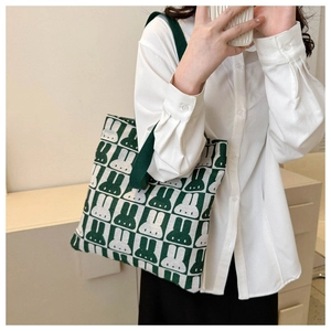 Detail of green and white checkerboard knit tote bag with cute rabbit pattern