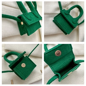 Detail view of green felt mini crossbody bag showing magnetic closure and interior space