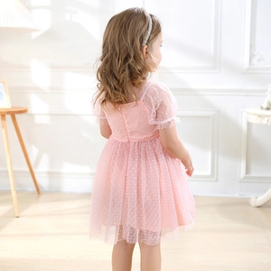 Detail of pink polka dot tulle dress for girls showing bubble sleeve and mesh texture