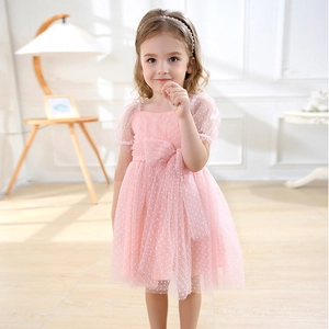 Detailed view of pink tulle dress featuring puff sleeves and a large waist bow for girls