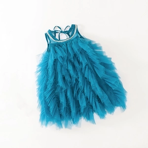 Detail of teal blue tiered tulle dress with sequin accents and pearl collar