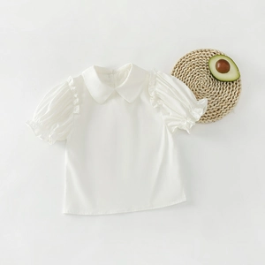 Detailed view of kids white puff sleeve shirt with Peter Pan collar and ruffle cuffs