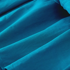 Detail of royal blue summer girl dress showing premium pleated fabric and layered design