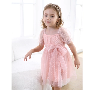 Detail of pink polka dot tulle dress for girls with bubble sleeves and waist bow