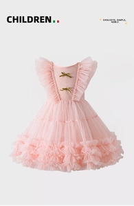 Detailed view of pink toddler dress with layered tulle ruffles and golden bows