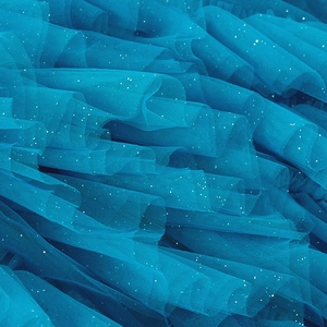 Close-up of turquoise tulle fabric with silver sequins and layered mesh details