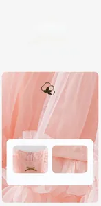 Detail of pink mesh fabric with a golden bow and cotton lining on a girl's party dress