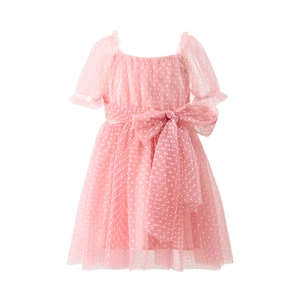Detailed view of pink tulle girl dress featuring white polka dots and a large waist bow