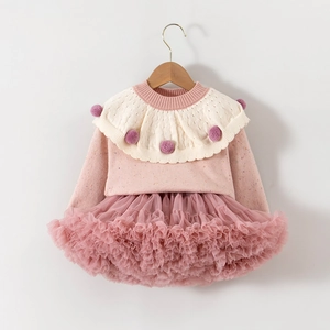 Detail of pink knitted sweater with ruffled collar and matching layered tulle tutu skirt