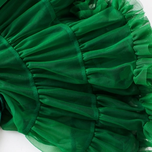 Detail of dark green tiered mesh fabric showing intricate pleats on girls tutu skirt