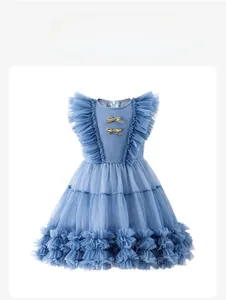 Detail of blue princess dress showing gold bows and ruffled mesh layered fabric textures