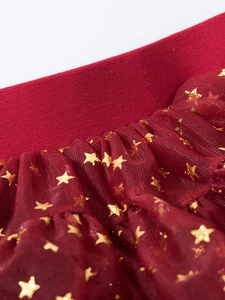Detail of red tutu skirt with golden star patterns and elastic waistband for girls