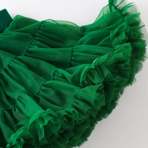 Detailed macro view of layered dark green tulle fabric and ruffled mesh ruffles