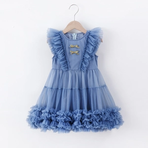 Close-up of light blue tulle dress with gold bows and tiered ruffle layered skirt