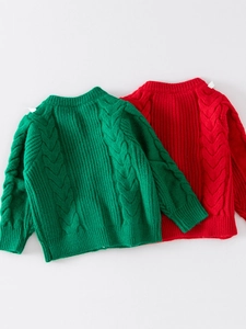 Close-up of forest green chunky knit sweater with classic cable knit sleeve texture