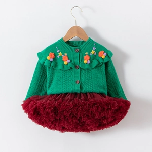 Detail of green knit cardigan with floral embroidery and red layered tulle tutu skirt