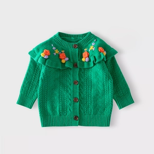 Detail of green knit girl cardigan with ruffle collar and colorful 3D floral embroidery
