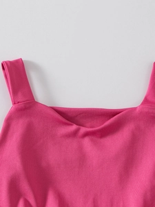 Detail of rose pink ballet dress featuring a square neckline and wide shoulder straps