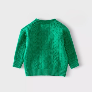 Close-up of vibrant green knit texture and cable stitch patterns on girls sweater