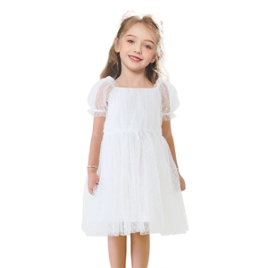 Close-up of white tulle princess dress with delicate polka dot texture and puff sleeves