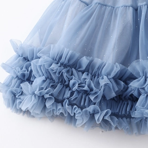 Close-up of light blue layered mesh tutu skirt with silver glitter and ruffle edges