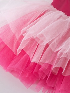 Detail of multi-layered pink gradient tulle skirt with ruffled layers for ballet dress