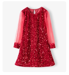 Detail of red sequined bodice with sheer pink tulle sleeves on girls' festive dress