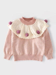 Pink knit sweater for girls with colorful nep yarn and a large ruffled collar detail