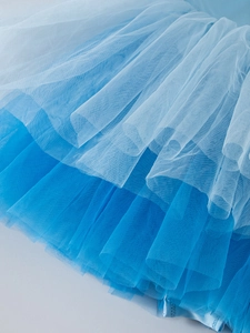 Detail of multi-layered light blue gradient tulle fabric on ballet tutu skirt for girls