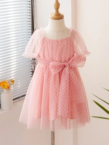 Pink tulle girls' dress with white polka dots, puff sleeves and a large waist bow