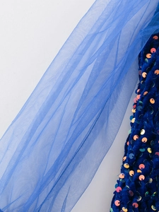 Detail of royal blue velvet fabric with colorful sequins and soft tulle mesh stitching