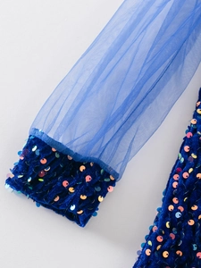 Detail of blue velvet cuffs with iridescent sequins and translucent mesh sleeves