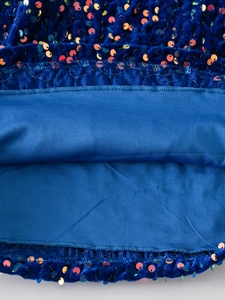 Close-up of navy blue velvet dress with shimmering sequins and premium sewing detail