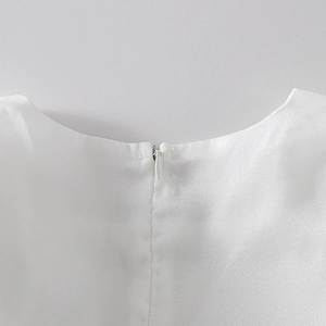 Detail of high-quality invisible zipper on the back of a white satin girl's dress