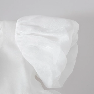Detailed macro view of puffy white organza sleeves with soft pearlescent finish