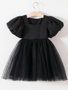 Girl's black princess dress with puffed sleeves and layered tulle skirt on a wooden hanger