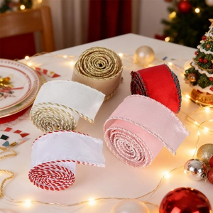 Close-up of five rolls of festive Christmas ribbons with decorative stitched edges
