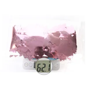 Pink metallic foil curtain on a scale showing 62.1g for party decoration background