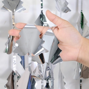 Macro view of silver foil Christmas tree tinsel curtain with reflective laser surface