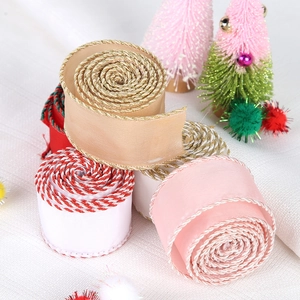Close-up of assorted Christmas ribbons with decorative metallic edges for gift wrapping