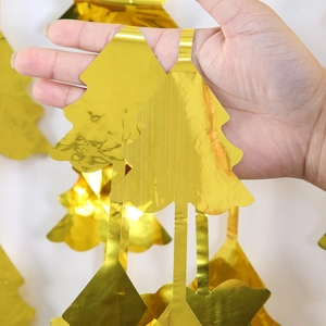 Close-up of golden tinsel foil Christmas tree curtain decoration with reflective finish