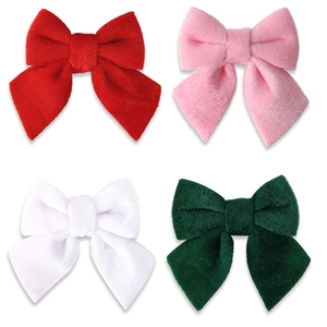 Set of four velvet Christmas bows in red, pink, white, and green for holiday decorations