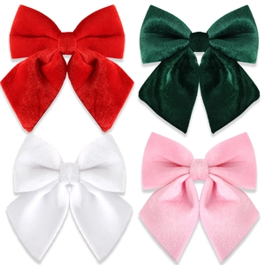 Set of four classic velvet Christmas bows in red, green, white, and pink for tree decoration